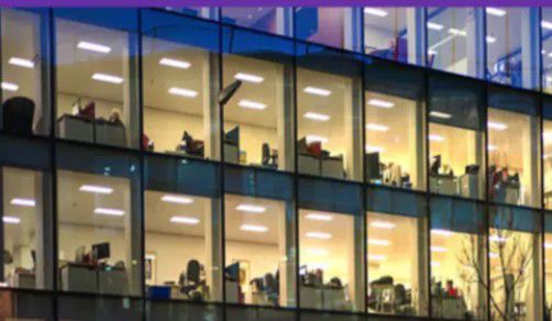 Office building lit up at night, Business Continuity & Disaster Recovery | DXC Technology